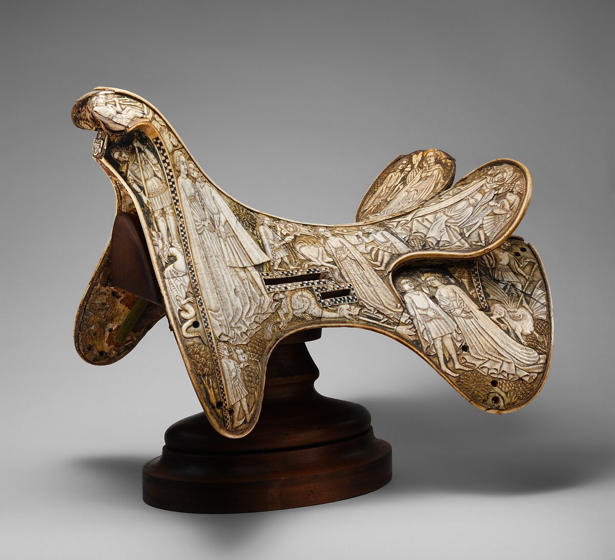 Saddle, Bovine bone (body of saddle), deer antler and bone (decorative elements), limewood, rawhide, birchbark, and metal paint, Central European