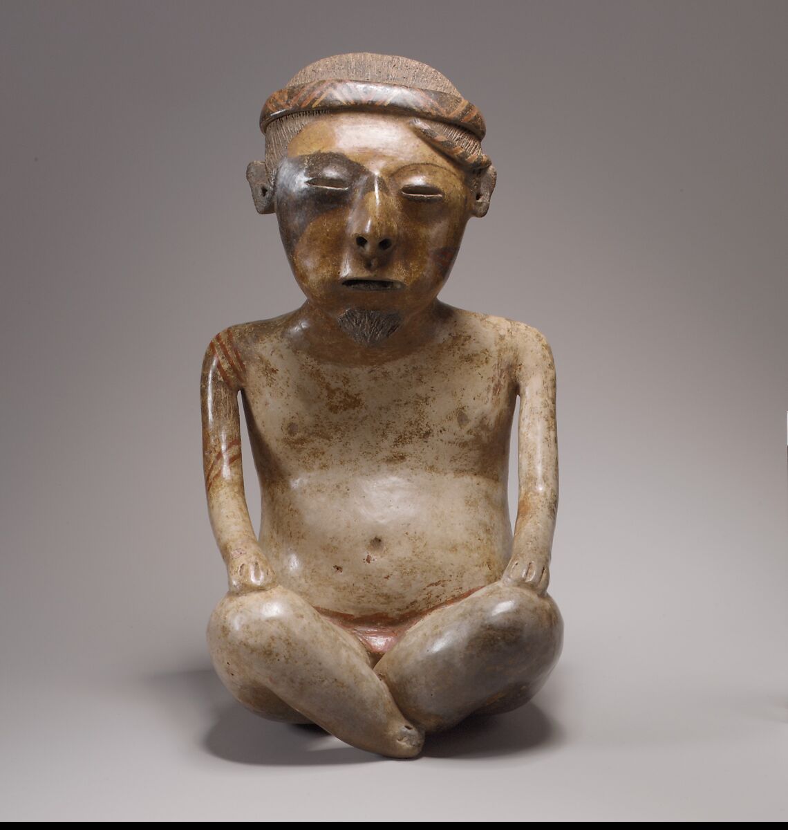 Seated male figure, Lagunillas artist(s), Ceramic, slip, Nayarit