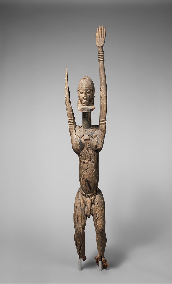 Priest with raised arms, Dogon blacksmith, Wood, applied organic materials, Dogon peoples