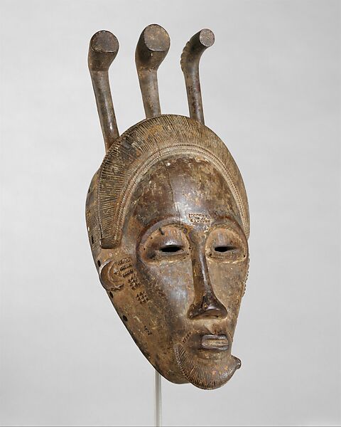 Portrait face mask from a mblo performance, Baule artist  Baoulé, Wood, pigment, iron, Baule